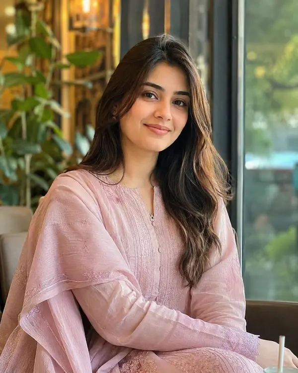 Barkat member in a light pink outfit
